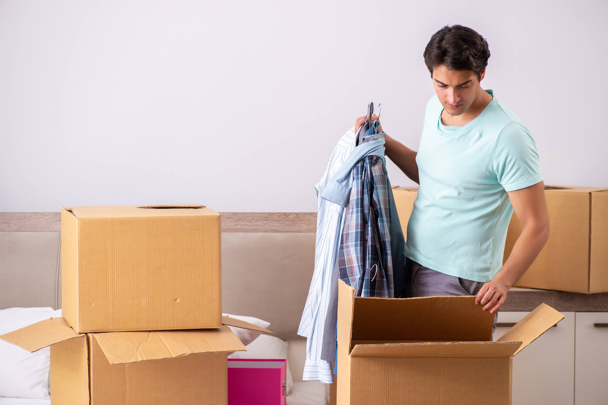 Man putting clothes in a box